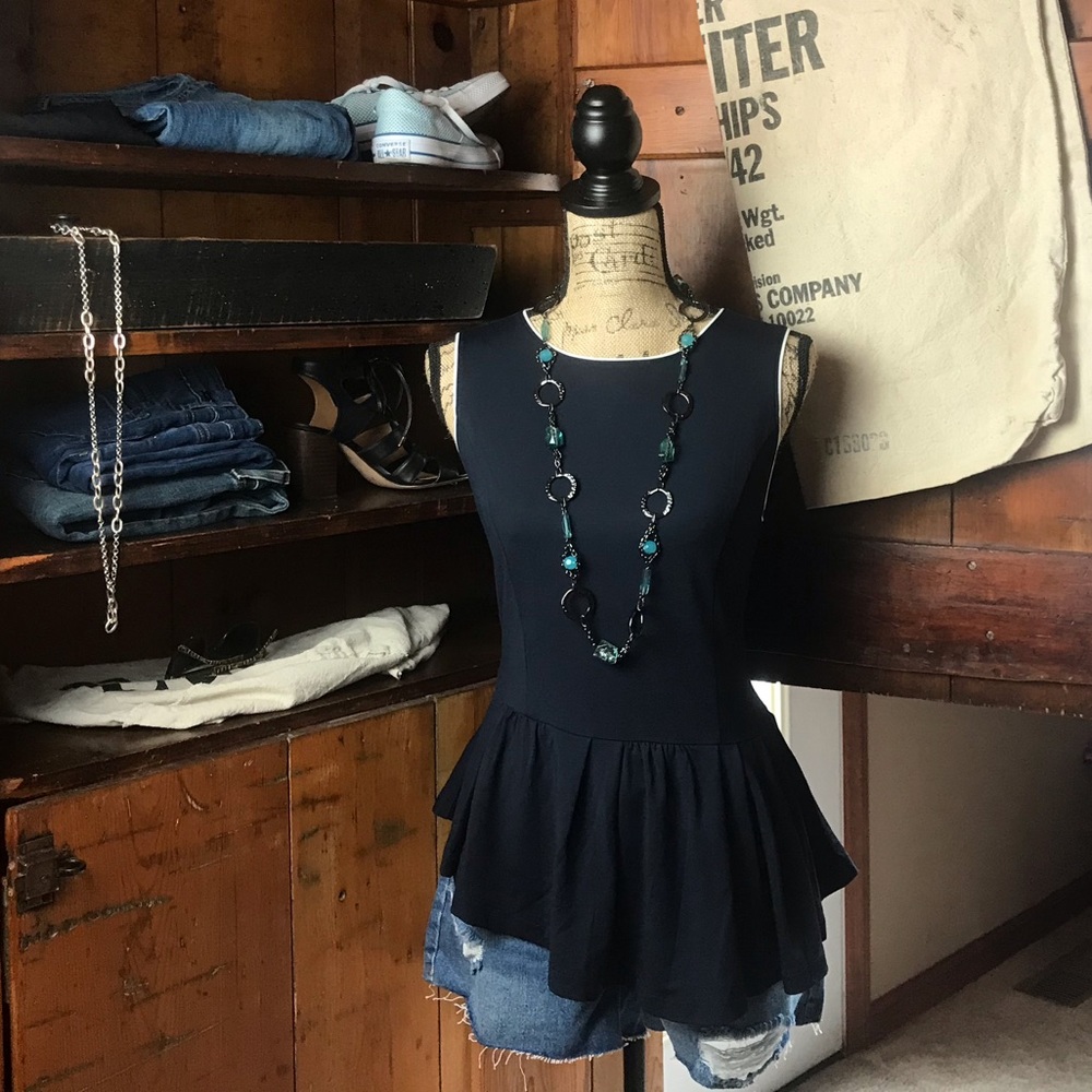 The limited navy asymmetrical ruffle hem blouse